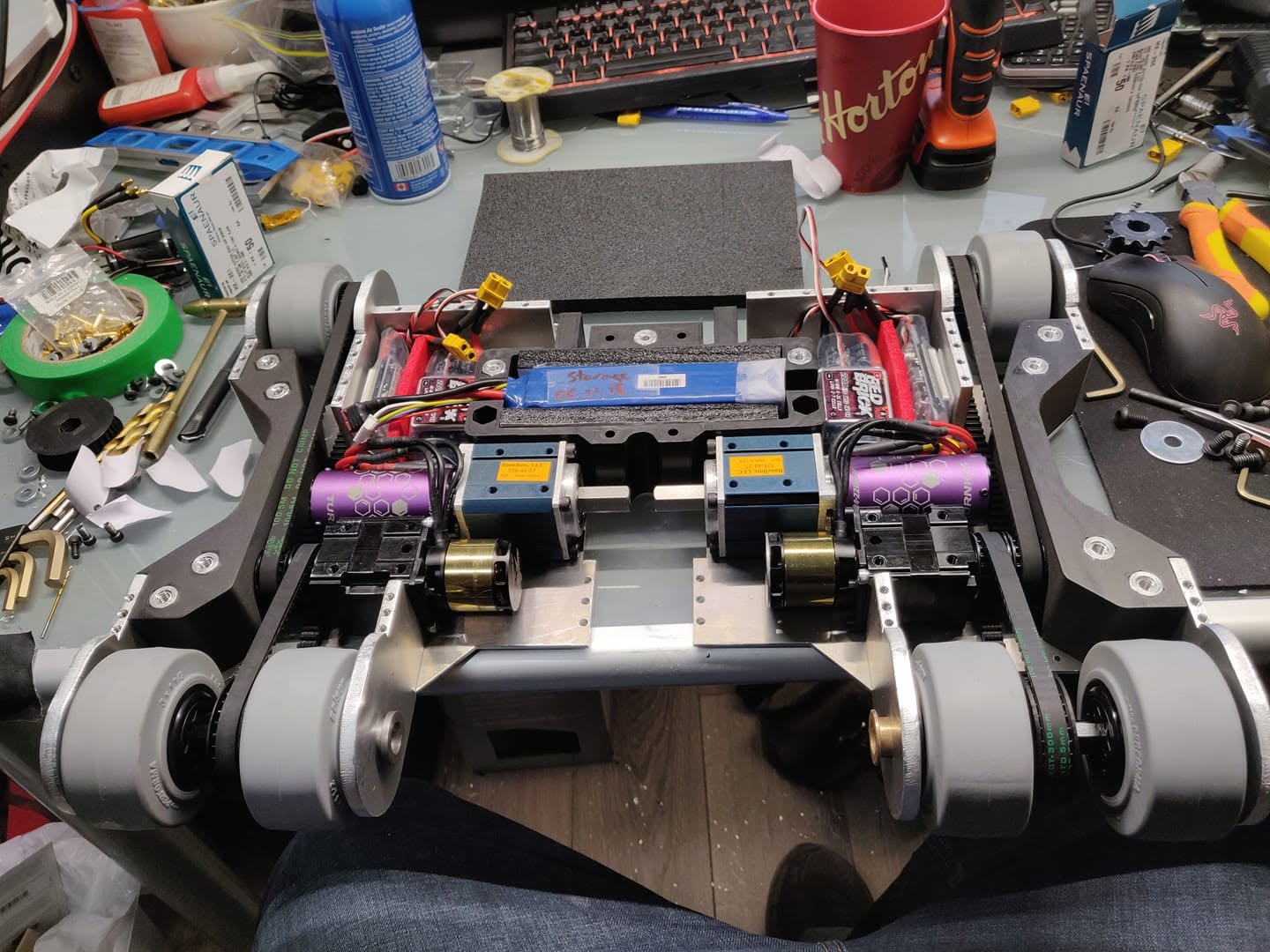 Internal electronics and drivetrain of a precision combat robot showing motors, ESCs, LiPo batteries and wiring harness