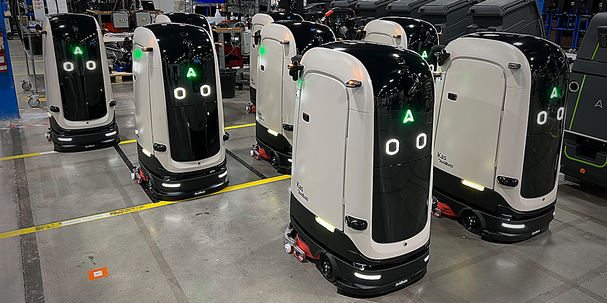 Fleet of Avidbots Kas autonomous floor-scrubbing robots on a factory floor